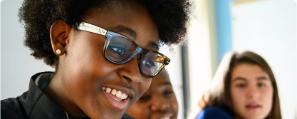 Girl wearing glasses working on code